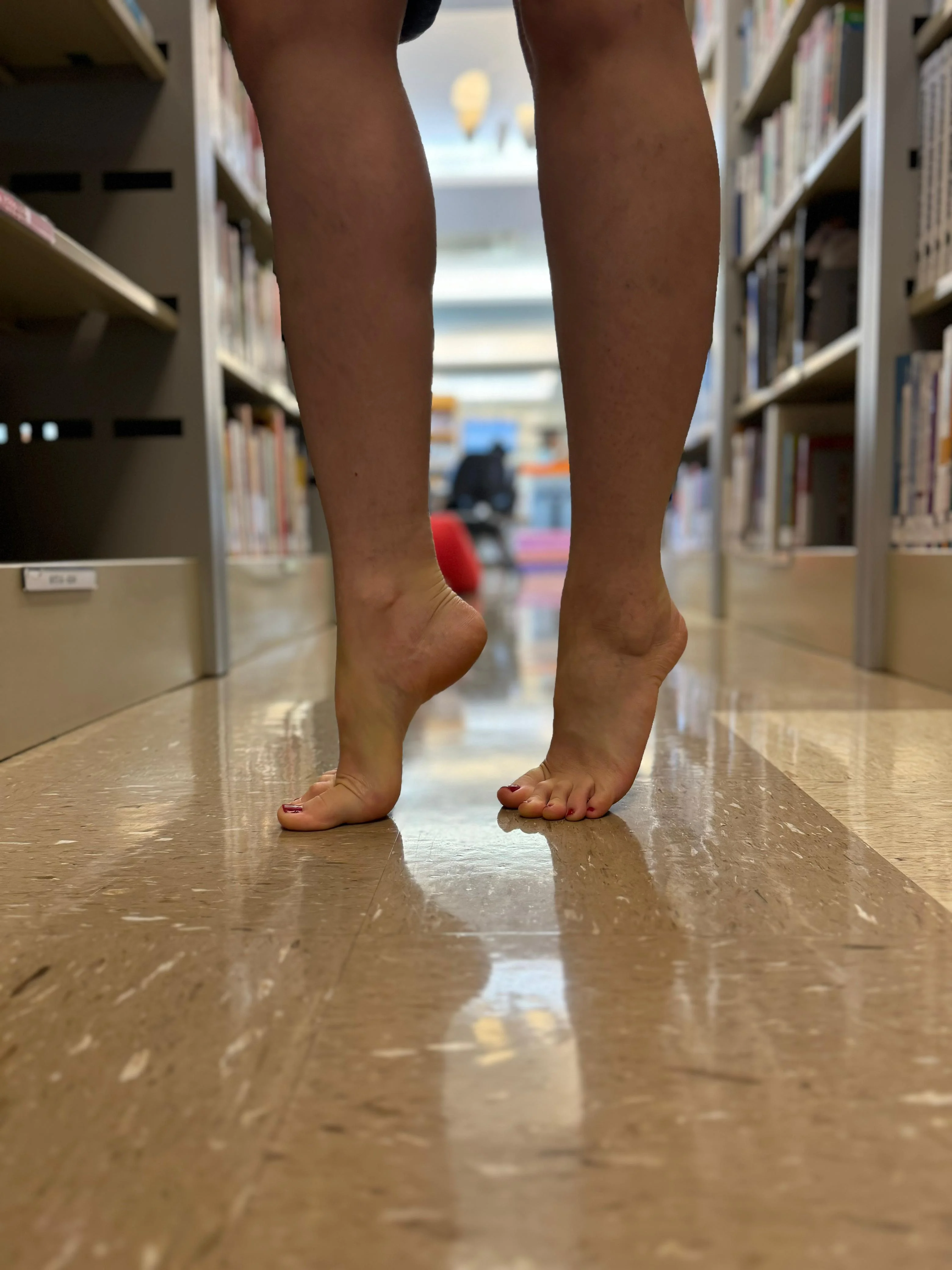 On tiptoes in the library picture 1 of 3
