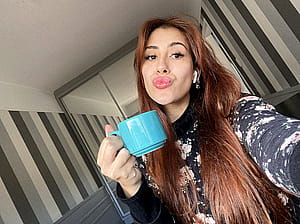 Sippin' on coffee, serving looks, Am I Hot?'