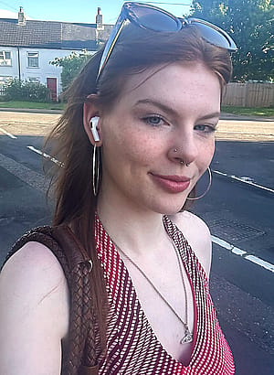 A classy red head wearing red dress'