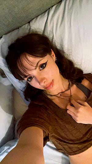 college girl is lying back down again after getting ready'